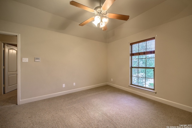 carpeted spare room featuring ceiling fan