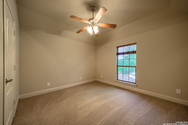 spare room featuring ceiling fan and light carpet