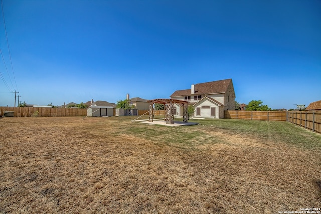 view of yard featuring a shed and a patio