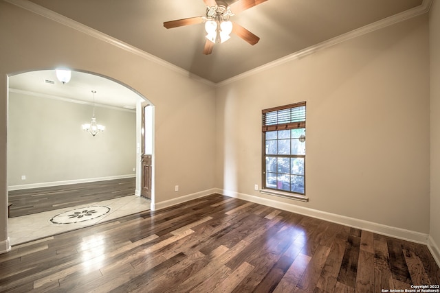 spare room with ornamental molding, dark hardwood / wood-style floors, and ceiling fan with notable chandelier