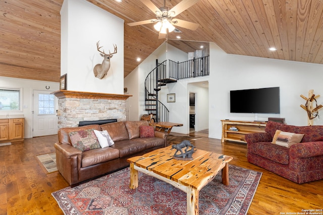 living room with wood-type flooring, high vaulted ceiling, a stone fireplace, and wood ceiling