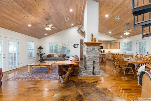 living room with wooden ceiling, light hardwood / wood-style flooring, high vaulted ceiling, and french doors