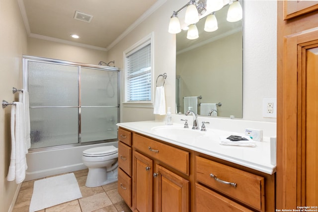 full bathroom with crown molding, tile patterned floors, enclosed tub / shower combo, toilet, and vanity