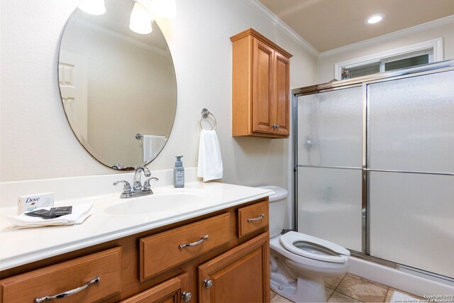 bathroom with toilet, vanity, ornamental molding, and walk in shower