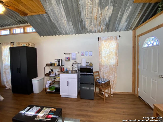 interior space featuring dark hardwood / wood-style flooring, ceiling fan, and sink