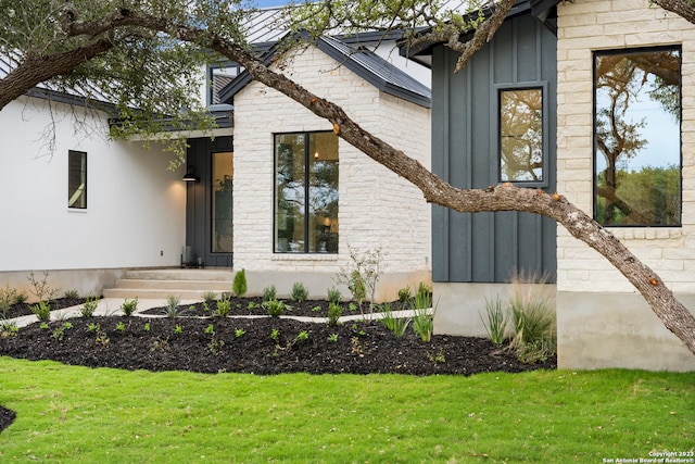 view of exterior entry featuring a yard