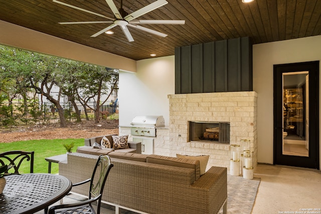 view of patio / terrace featuring area for grilling, an outdoor living space with a fireplace, and ceiling fan