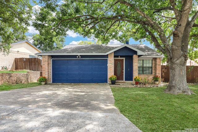 ranch-style house featuring a front lawn and a garage