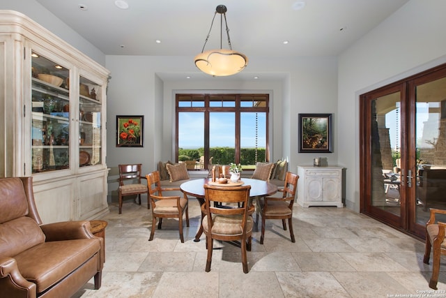 dining area with light tile floors and french doors