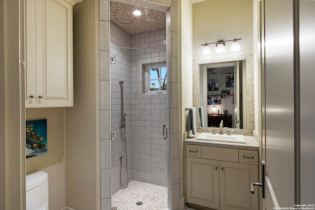 bathroom with toilet, oversized vanity, and a shower with shower door