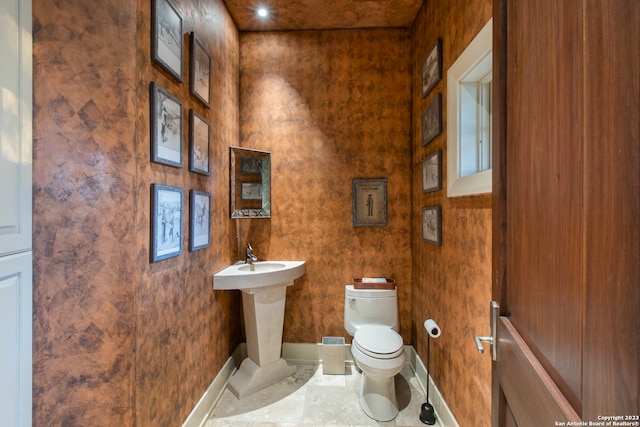 bathroom featuring toilet and tile flooring