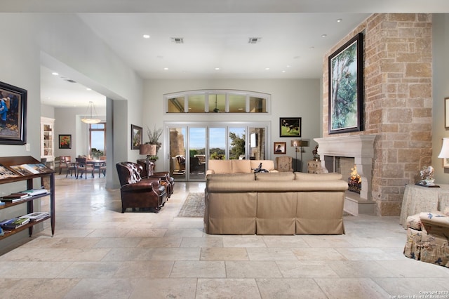 living room with light tile floors and a high ceiling