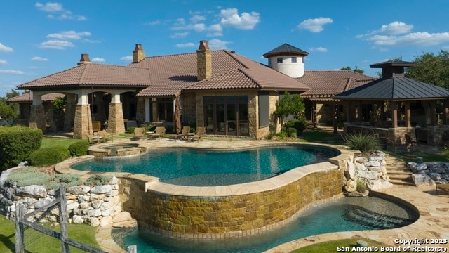 view of pool with a gazebo, an in ground hot tub, and a patio