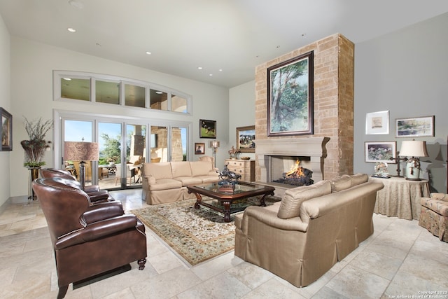 tiled living room with brick wall, a large fireplace, and a high ceiling