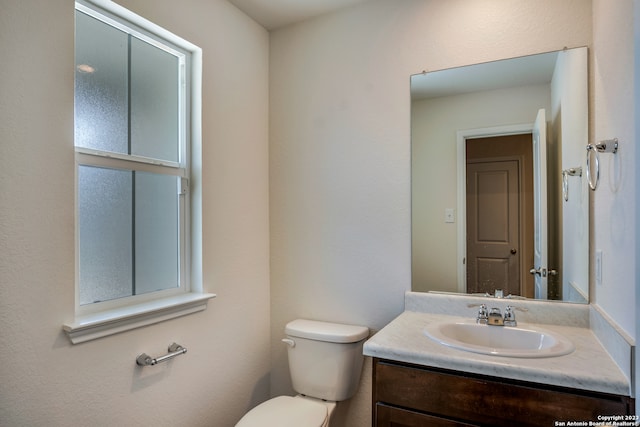 bathroom featuring toilet and vanity