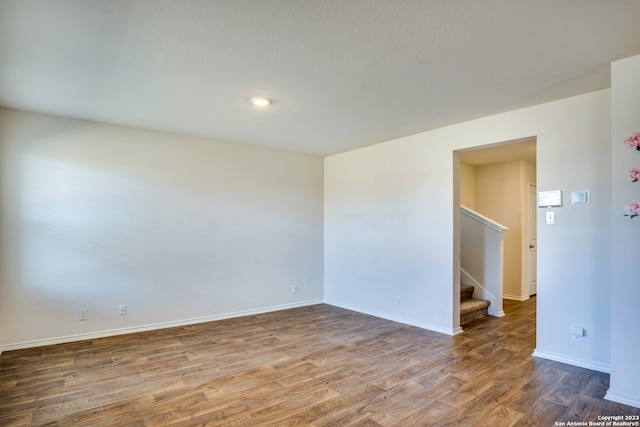 spare room with dark wood-type flooring