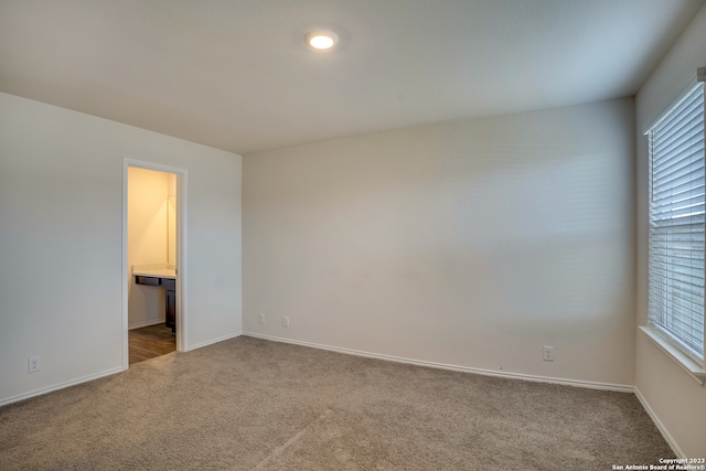 carpeted empty room with plenty of natural light