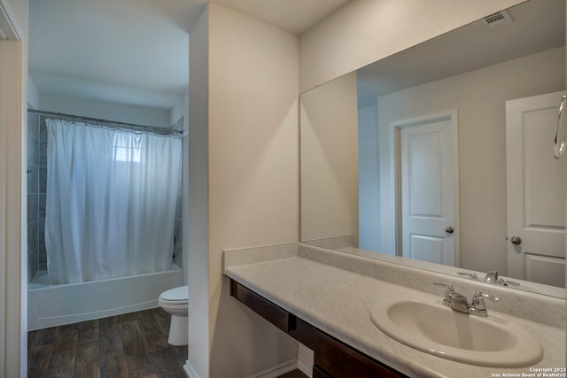 full bathroom with hardwood / wood-style floors, shower / bath combination with curtain, toilet, and vanity