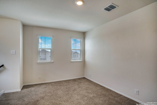 empty room with dark carpet