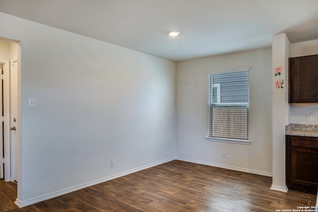 unfurnished dining area featuring dark hardwood / wood-style flooring