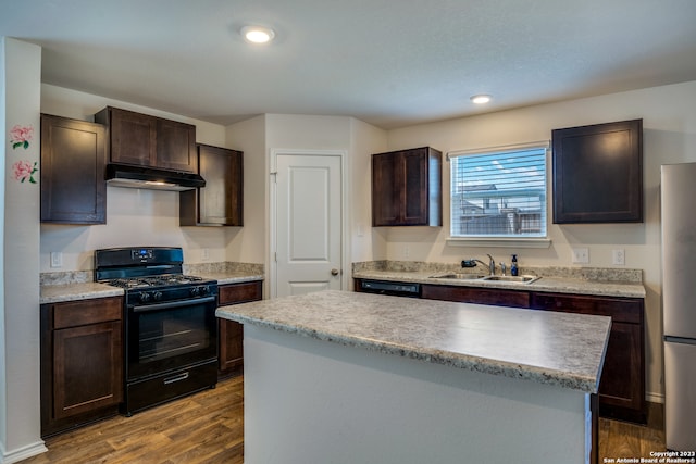 kitchen with gas stove, sink, a kitchen island, hardwood / wood-style floors, and dark brown cabinetry