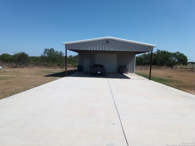 garage with a yard and a carport