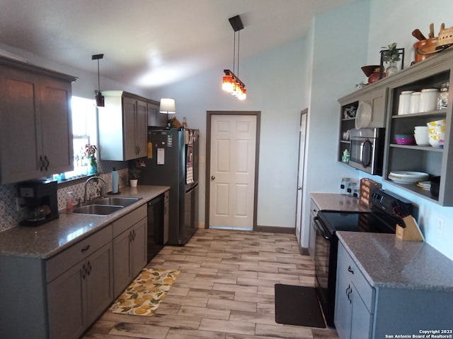 kitchen featuring pendant lighting, sink, backsplash, black appliances, and light wood-type flooring