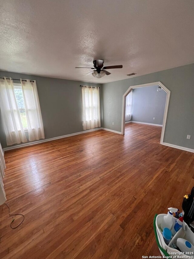 spare room featuring ceiling fan, hardwood / wood-style floors, and a textured ceiling