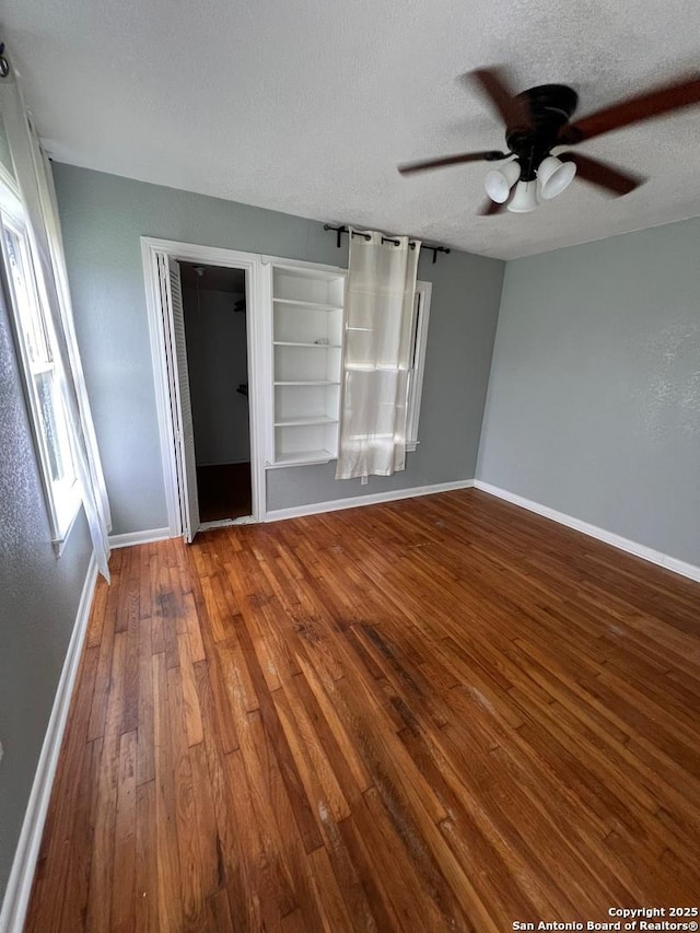 interior space with ceiling fan, hardwood / wood-style floors, and a textured ceiling