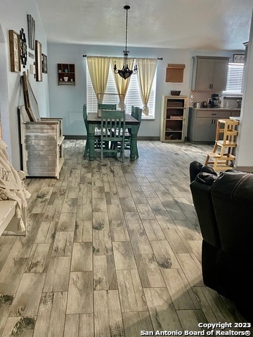 dining area featuring an inviting chandelier and light hardwood / wood-style floors