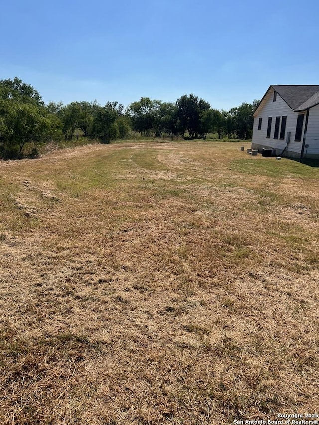 view of yard with a rural view