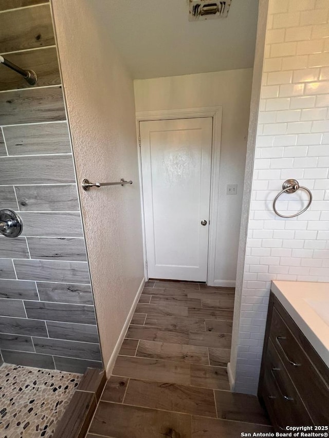 bathroom featuring vanity and a shower