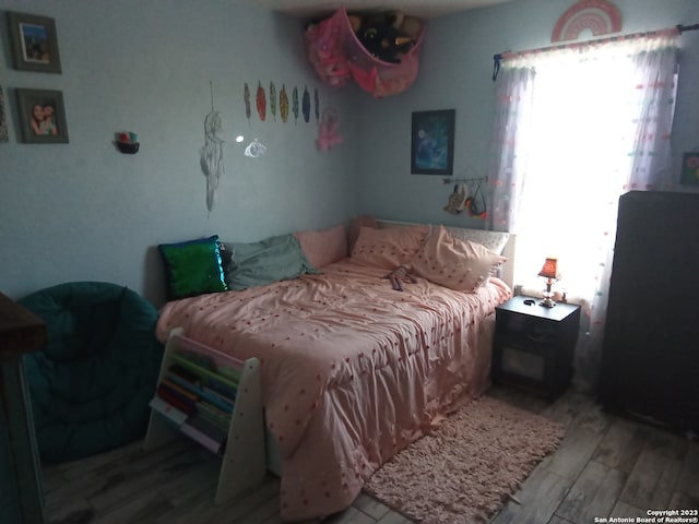 bedroom with light hardwood / wood-style flooring