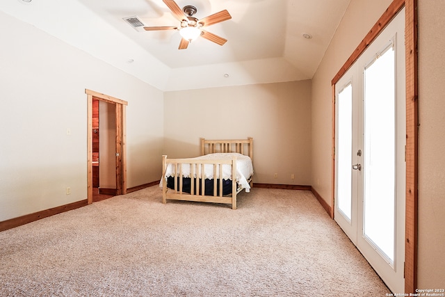 unfurnished bedroom with ceiling fan, light colored carpet, and a tray ceiling