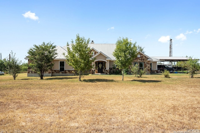 obstructed view of property featuring a carport and a front lawn