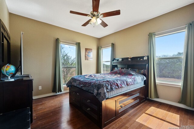 bedroom with ceiling fan and dark hardwood / wood-style floors