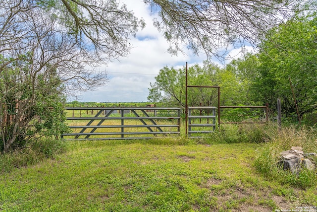 view of gate with a yard