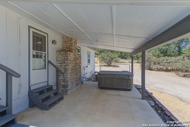 view of patio / terrace featuring a hot tub