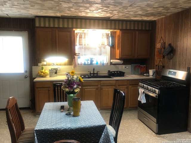 kitchen with stainless steel gas range, sink, and beverage cooler