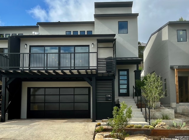 view of front facade with a balcony and a garage