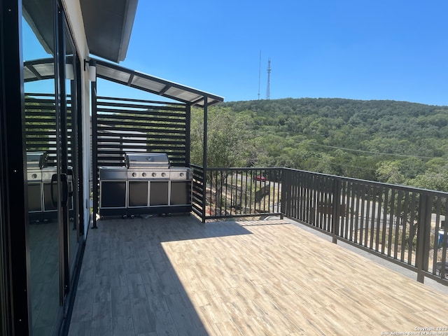 wooden deck featuring a grill