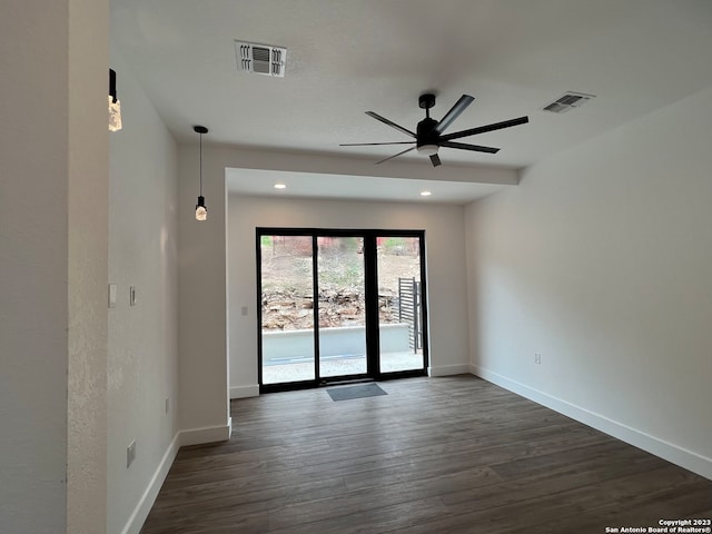 unfurnished room with dark hardwood / wood-style floors and ceiling fan