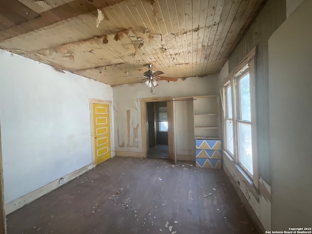 spare room with a healthy amount of sunlight, ceiling fan, and wooden ceiling