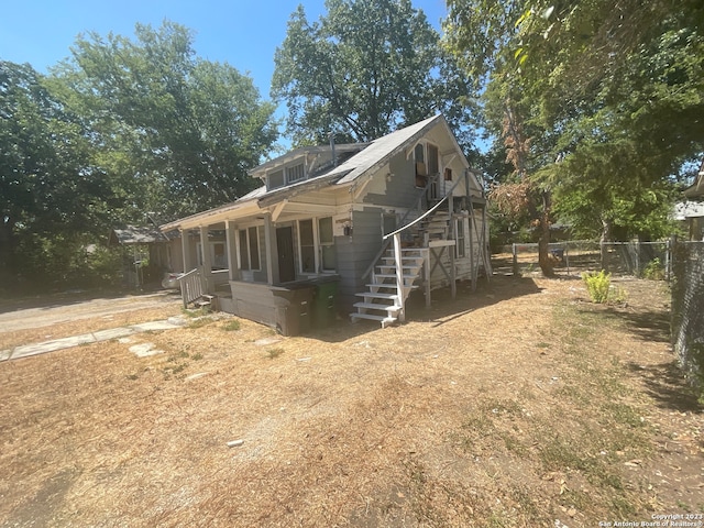 view of property exterior featuring covered porch