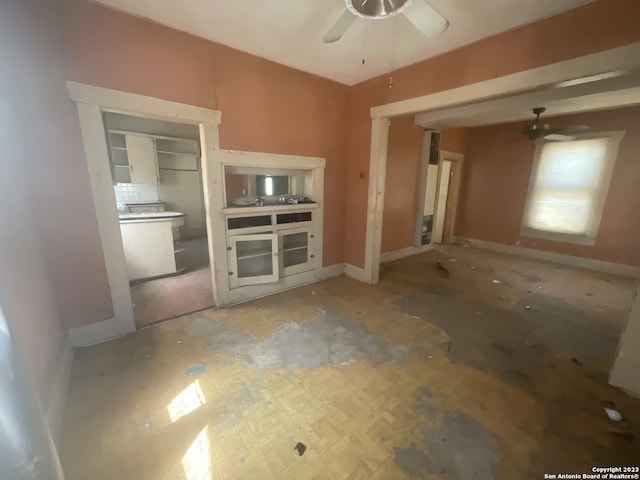 unfurnished living room featuring ceiling fan