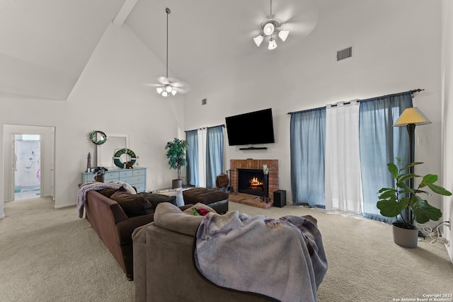 living room featuring ceiling fan, a fireplace, light carpet, and high vaulted ceiling