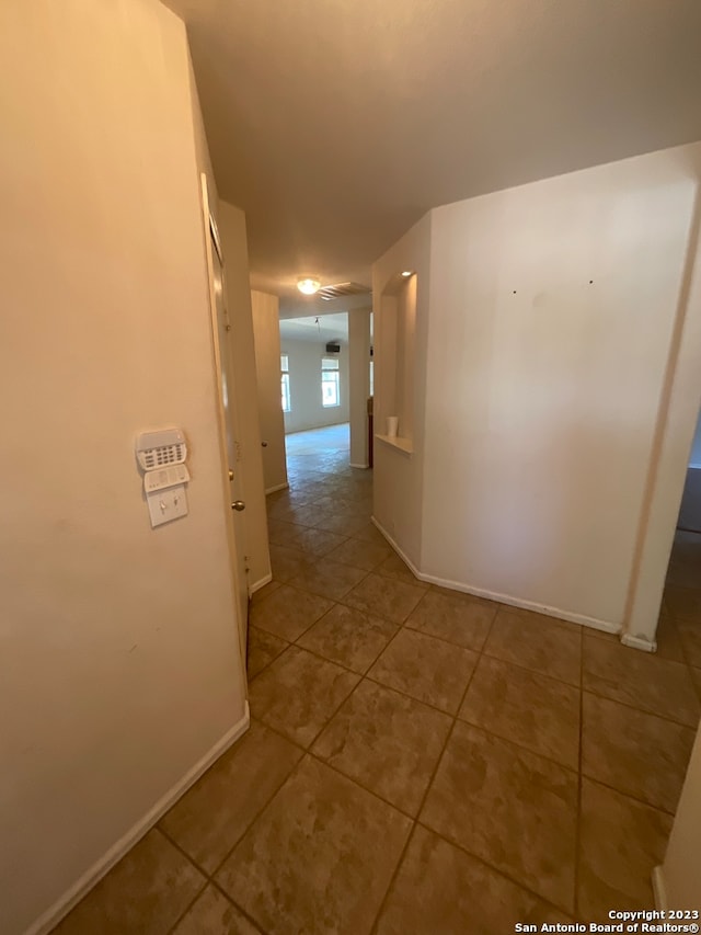 hall featuring light tile floors