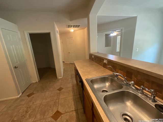 kitchen featuring ceiling fan, light tile floors, and sink