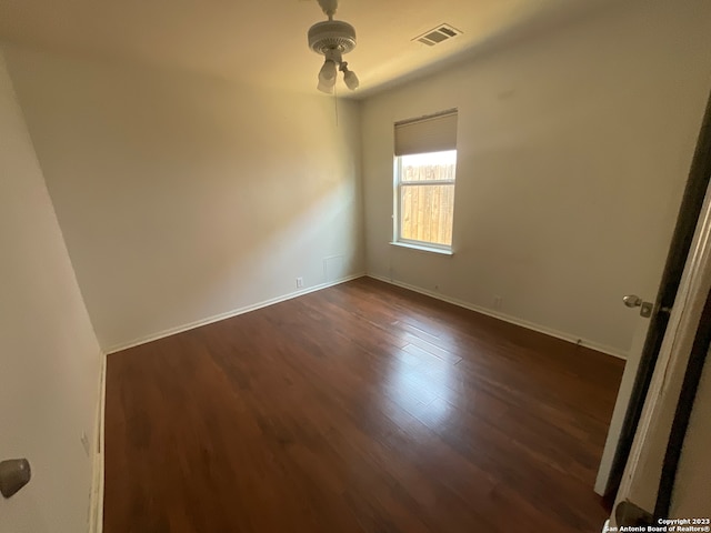 spare room with dark hardwood / wood-style floors