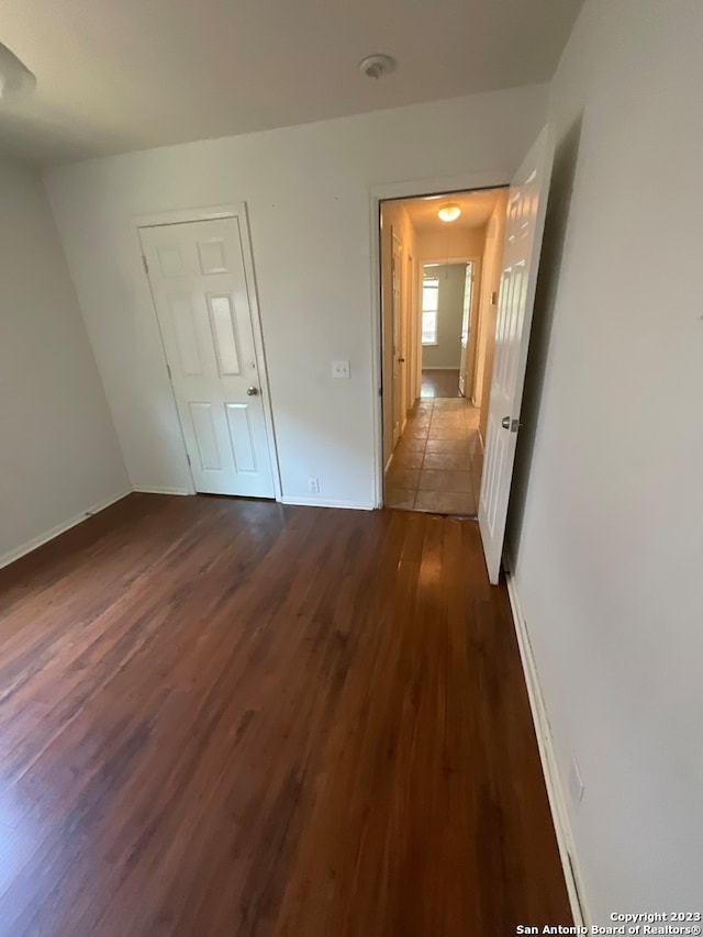 unfurnished bedroom with dark hardwood / wood-style floors